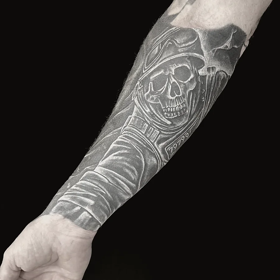 Black and grey realism sleeve tattoo on forearm, healed skin