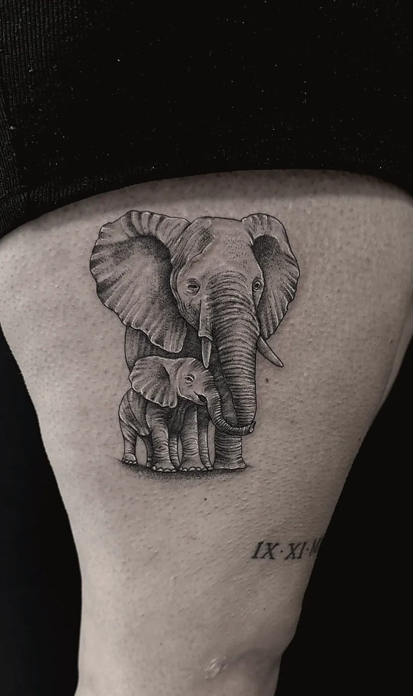 Realism tattoo of an elephant mother and calf in black and grey
